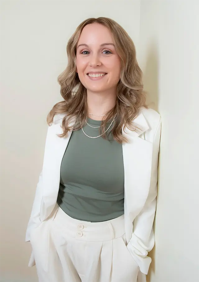 amanda stickel in white jacket and pants with green shirt